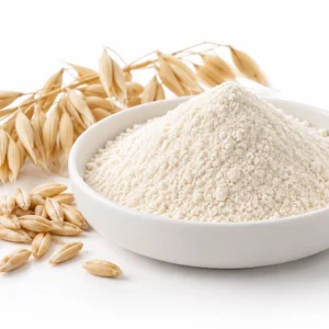 Off-white oat beta-glucan powder in a white dish beside oat grains and oat heads on a white background