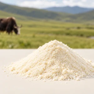 Pale ivory powder on a smooth light-colored surface, with a yak softly blurred in the background